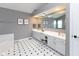 Bathroom with double vanity, gray walls, white trim and white tiled floors at 11050 Midnight Pass, Fishers, IN 46037