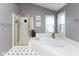 Sunlit bathroom featuring a soaking tub with tile surround and glass-enclosed shower at 11050 Midnight Pass, Fishers, IN 46037