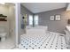 Bright bathroom with large soaking tub, glass shower, and tiled floors at 11050 Midnight Pass, Fishers, IN 46037
