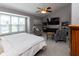 Spacious primary bedroom featuring a vaulted ceiling, ceiling fan, sitting area, and a large window at 11050 Midnight Pass, Fishers, IN 46037