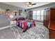 Cozy bedroom with neutral walls, ceiling fan, and large windows at 11050 Midnight Pass, Fishers, IN 46037