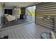 Covered patio with lounge seating, grill, and view of backyard pool at 11050 Midnight Pass, Fishers, IN 46037
