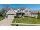 Charming two-story home with a brick facade, well-manicured lawn, and an attached two-car garage at 11050 Midnight Pass, Fishers, IN 46037