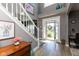 Bright foyer with a staircase, decorative accents, and an open view to the front door and exterior at 11050 Midnight Pass, Fishers, IN 46037