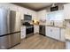 A bright, updated kitchen featuring stainless steel appliances, granite countertops, and white cabinets at 11050 Midnight Pass, Fishers, IN 46037