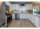 Bright kitchen features stainless appliances, subway tile backsplash, granite countertops, and backyard access at 11050 Midnight Pass, Fishers, IN 46037