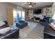 Cozy living room featuring a fireplace, built-in shelving, and sliding doors that lead to an outdoor patio at 11050 Midnight Pass, Fishers, IN 46037