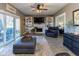Relaxing living room with built-in shelving, fireplace, and sliding glass doors offering seamless indoor-outdoor living at 11050 Midnight Pass, Fishers, IN 46037