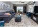 Spacious living room with a cozy seating arrangement, shelving, and lots of natural light at 11050 Midnight Pass, Fishers, IN 46037