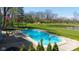 Sparkling in-ground pool surrounded by lush greenery and a well-manicured lawn, ideal for summer fun at 11050 Midnight Pass, Fishers, IN 46037