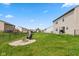 Wide view of the backyard featuring a new fire pit, swing set, and great space to entertain at 1167 Dark Star Ct, New Whiteland, IN 46184