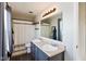 Bathroom with double sink vanity, large mirror, and shower with a curtain at 1167 Dark Star Ct, New Whiteland, IN 46184