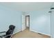 Light blue bedroom featuring neutral carpet, white trim and doors, and an inviting, airy atmosphere at 1167 Dark Star Ct, New Whiteland, IN 46184