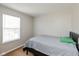 Simple bedroom with neutral walls, carpet, and natural light from a window at 1167 Dark Star Ct, New Whiteland, IN 46184
