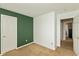 Bedroom with green accent wall, carpet flooring, and white trim throughout at 1167 Dark Star Ct, New Whiteland, IN 46184