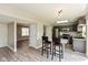 Open-concept kitchen featuring barstool seating and stainless steel appliances, connecting to the living areas at 1167 Dark Star Ct, New Whiteland, IN 46184