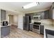 Modern kitchen featuring stainless steel appliances, granite countertops, and gray cabinets at 1167 Dark Star Ct, New Whiteland, IN 46184