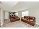 Bright living room with updated flooring, neutral paint, and two plush leather couches at 1167 Dark Star Ct, New Whiteland, IN 46184