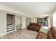 Open-concept living room features a staircase, modern flooring, and comfortable leather seating at 1167 Dark Star Ct, New Whiteland, IN 46184