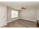 Bright living room featuring wood-look flooring, a ceiling fan, and a window offering natural light at 1167 Dark Star Ct, New Whiteland, IN 46184