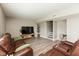 Cozy living room with a leather sofa, television, wood-look floors and stairs leading to another floor at 1167 Dark Star Ct, New Whiteland, IN 46184