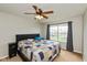 Bedroom featuring a ceiling fan, large window, and comfortable-looking bed with a patterned quilt at 1167 Dark Star Ct, New Whiteland, IN 46184