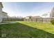 Fenced backyard featuring a grassy lawn and patio area, perfect for outdoor living and privacy at 12344 Bearsdale Dr, Indianapolis, IN 46235