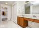 Bright bathroom featuring a double sink vanity, closet, and separate toilet area at 12344 Bearsdale Dr, Indianapolis, IN 46235