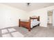 Bright bedroom featuring a wooden bed frame, light walls and carpet, and an ensuite bathroom at 12344 Bearsdale Dr, Indianapolis, IN 46235
