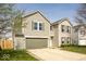 Attractive two-story home showcasing a two-car garage, complemented by neutral siding and brick accents at 12344 Bearsdale Dr, Indianapolis, IN 46235