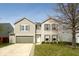 Charming two-story home featuring a well-maintained lawn and a two-car garage, complemented by neutral siding at 12344 Bearsdale Dr, Indianapolis, IN 46235
