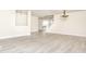 Open-concept living room featuring modern gray floors, neutral paint, staircase, and bright natural light at 12344 Bearsdale Dr, Indianapolis, IN 46235