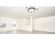 Bright living room featuring gray floors, neutral paint, and natural light, with a modern chandelier overhead at 12344 Bearsdale Dr, Indianapolis, IN 46235