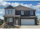 Two-story home featuring a brick exterior, two-car garage, and classic architectural design at 1378 Foxtail Ln, Greenwood, IN 46143