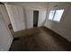 Bedroom featuring neutral-toned walls, a window, and multiple doors at 1524 Ohio Ave, Anderson, IN 46016