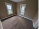 Bedroom with carpet, two windows, and neutral paint at 1524 Ohio Ave, Anderson, IN 46016
