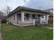 Cozy home with covered porch and vinyl siding, complemented by a compact front lawn at 1524 Ohio Ave, Anderson, IN 46016