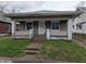 Charming single-story home featuring a covered front porch and a quaint yard at 1524 Ohio Ave, Anderson, IN 46016