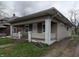 Exterior view of a modest home with a covered front porch and small front yard at 1524 Ohio Ave, Anderson, IN 46016