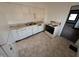 View of the kitchen with white cabinets and linoleum flooring at 1524 Ohio Ave, Anderson, IN 46016