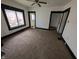 Spacious living room featuring neutral carpet, bright white walls, and dark trim at 1524 Ohio Ave, Anderson, IN 46016