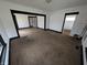 A bright living room offers spacious living, neutral carpeting, and dark trim at 1524 Ohio Ave, Anderson, IN 46016