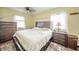 Bedroom with hardwood floors features a bed, side tables, and natural light windows at 16371 State Road 38 E, Noblesville, IN 46060