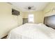 Bedroom with hardwood floors features a bed, side tables, and natural light window at 16371 State Road 38 E, Noblesville, IN 46060