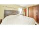 Bedroom with hardwood floors features a bed, side tables, and closet at 16371 State Road 38 E, Noblesville, IN 46060