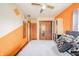 Spacious bedroom with orange accent wall, ceiling fan, closet, and neutral carpet at 16371 State Road 38 E, Noblesville, IN 46060
