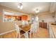Dining area with a wooden table, seating for six, wood floors and an open view into the kitchen at 16371 State Road 38 E, Noblesville, IN 46060
