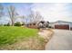 A spacious house and garage are accompanied by a cozy seating area outside the back at 16371 State Road 38 E, Noblesville, IN 46060