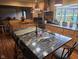 Spacious kitchen island featuring granite countertops, stainless steel sink, gooseneck faucet, and seating for entertaining at 16371 State Road 38 E, Noblesville, IN 46060