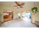 Bright sunroom with tile flooring, ceiling fan, and views into kitchen and sunroom at 16371 State Road 38 E, Noblesville, IN 46060